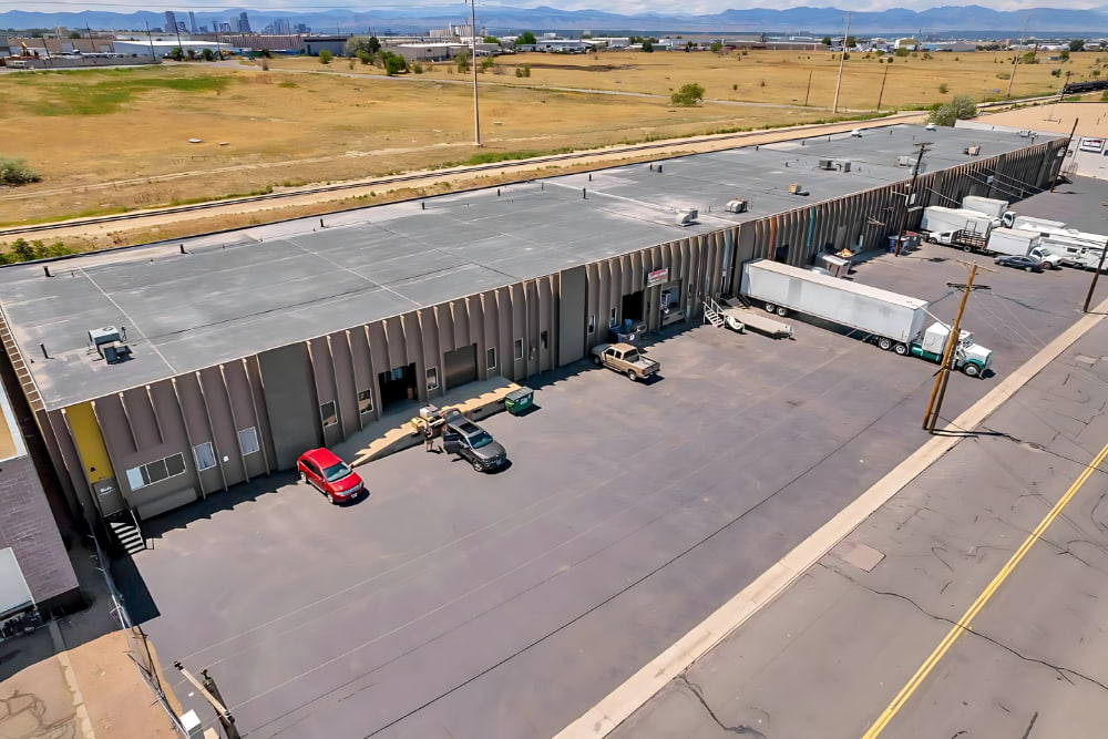 Exterior view of newly leased Commerce City industrial warehouse with loading dock and truck parking